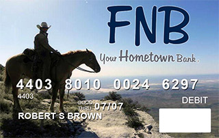 debit card depicting a mounted cowboy in the hill country