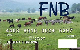 debit card showing a field with cattle grazing in it